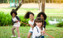 Group,Of,Children,Playing,Tug,Of,War,At,The,Park
